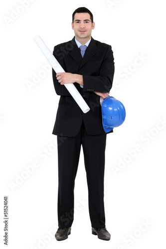 Photo: Businessman holding helmet and blueprints Businessman holding helmet and blueprints