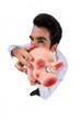 Man standing on white background showing piggy bank