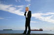 Businesswoman talking on her mobile phone on the quay