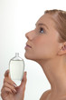 Woman holding perfume bottle