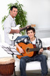 Foto: Father teaching son how to play the guitar Father teaching son how to play the guitar