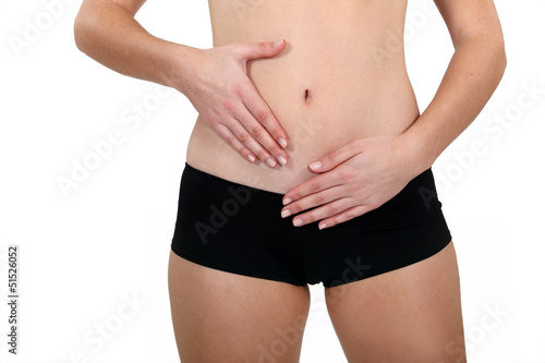 Photo: Female hands touching belly Female hands touching belly
