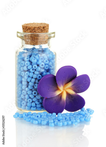 Photo: Little bottle full with colorful beads isolated on white Little bottle full with colorful beads isolated on white