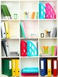 White office shelves with different stationery, close up