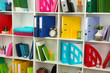 White office shelves with different stationery, close up