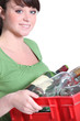 Photo: Young woman taking out the recycling Young woman taking out the recycling