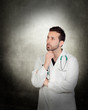 Photo: Portrait Of Young Thoughtful Male Doctor Portrait Of Young Thoughtful Male Doctor