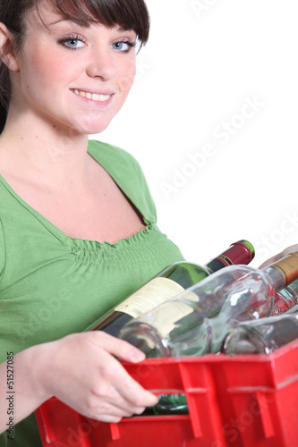Photo: Young woman taking out the recycling Young woman taking out the recycling