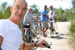 Foto: a senior man doing bike with friends in summer a senior man doing bike with friends in summer