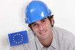 Foto: Smiling laborer with European flag Smiling laborer with European flag