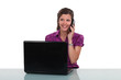 Photo: Young woman at a desk with laptop and phone Young woman at a desk with laptop and phone