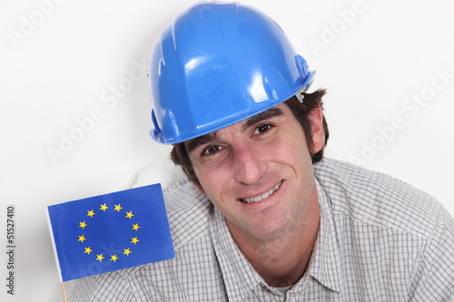 Photo: Smiling laborer with European flag Smiling laborer with European flag