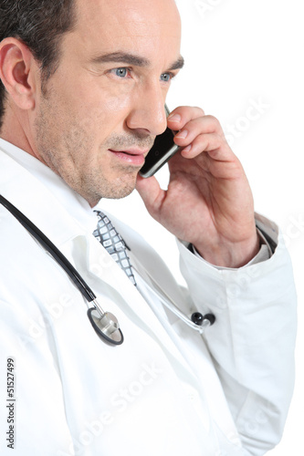 Photo: Doctor on phone smiling Doctor on phone smiling