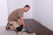 Man installing parquet flooring