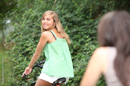 Photo: Two teenage girls on bike ride Two teenage girls on bike ride