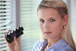 Photo: Blond woman using binoculars Blond woman using binoculars