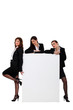 Three businesswomen with blank poster