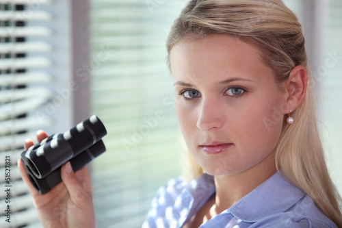 Photo: Blond woman using binoculars Blond woman using binoculars