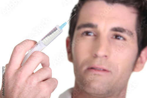 Photo: Man with syringe in hand Man with syringe in hand