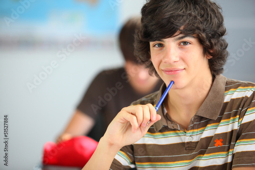 Photo: A teenage boy in the classroom A teenage boy in the classroom