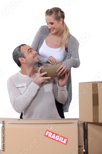 Photo: couple arranging their new apartment couple arranging their new apartment