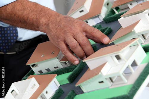 Photo: Man with a model of a housing estate Man with a model of a housing estate