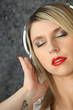 Foto: blonde woman with closed eyes listening to music blonde woman with closed eyes listening to music