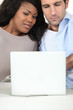 Mixed race couple with laptop