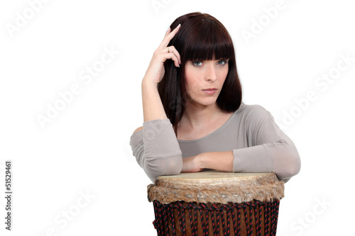 Photo: Pensive woman resting on a drum Pensive woman resting on a drum