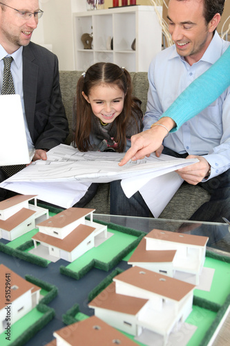 Photo: Young family excited about new house Young family excited about new house