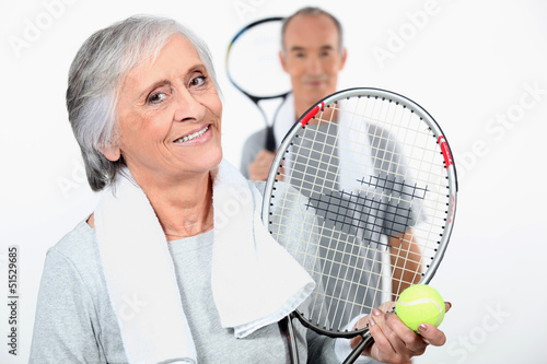 Photo: Elderly couple playing tennis Elderly couple playing tennis