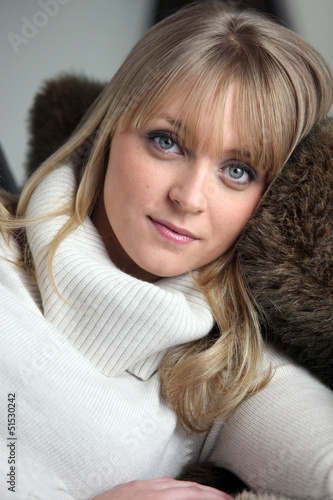Photo: portrait of blond woman lying on a sofa portrait of blond woman lying on a sofa