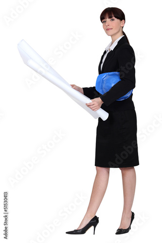 Photo: Female architect holding plans Female architect holding plans