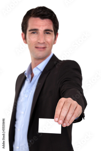 Photo: A businessman handing his card. A businessman handing his card.
