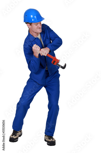 Photo: Tradesman using a wrench Tradesman using a wrench