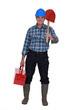Tradesman carrying a spade and a toolbox