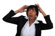 Scared businesswoman covering her head