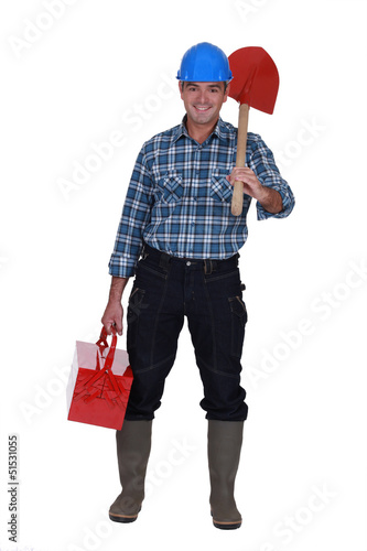 Photo: Tradesman carrying a spade and a toolbox Tradesman carrying a spade and a toolbox