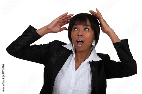 Photo: Scared businesswoman covering her head Scared businesswoman covering her head