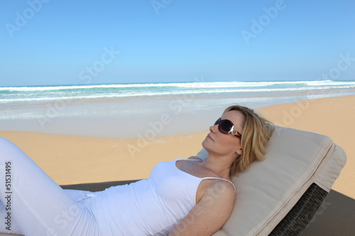Photo: Woman lying on a lounger Woman lying on a lounger