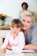 Foto: Mother and daughter reading a book together Mother and daughter reading a book together