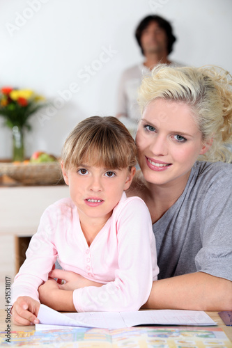 Photo: Mother and daughter reading a book together Mother and daughter reading a book together