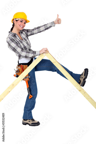 Photo: Peppy woman holding up a wooden frame Peppy woman holding up a wooden frame