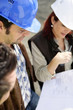 Photo: Architects looking plan Architects looking plan