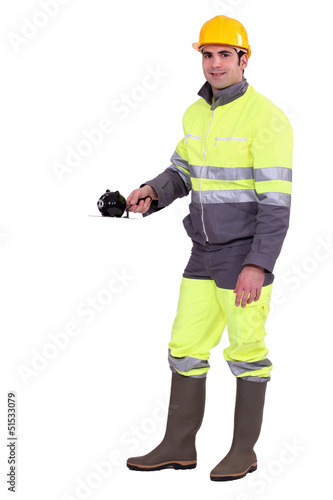 Photo: Worker with a piggy bank Worker with a piggy bank