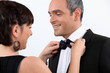 Wife helping husband with bow tie