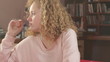 Young pensive woman sitting in the room, tracking shot