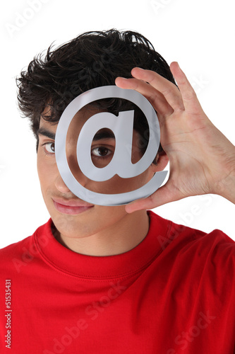 Photo: Man holding metallic at symbol Man holding metallic at symbol