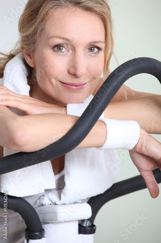 Photo: Woman using cycling machine to stay fit Woman using cycling machine to stay fit