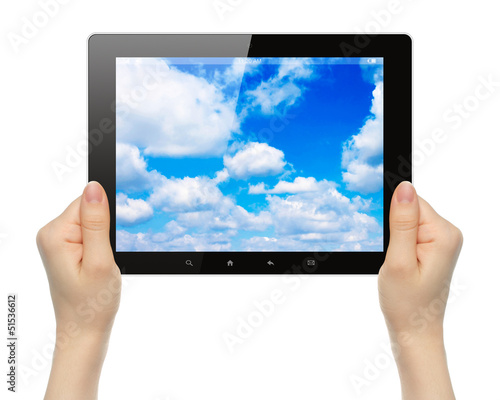 Photo: Woman hands holding tablet PC with sky on white background . Woman hands holding tablet PC with sky on white background .